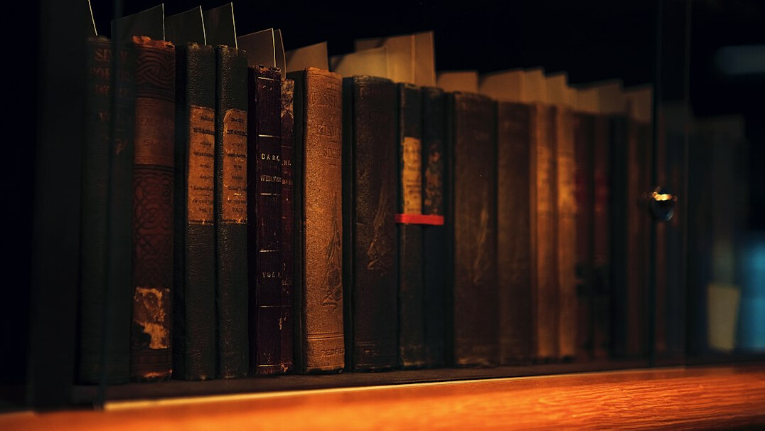 Shelf of old books in warm light
